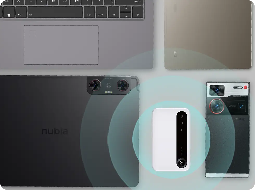 Na płaskiej powierzchni ułożone są różne urządzenia elektroniczne. Wśród nich znajduje się laptop z widoczną klawiaturą, dwa tablety — jeden z napisem nubia, drugi z etykietą ZTE.