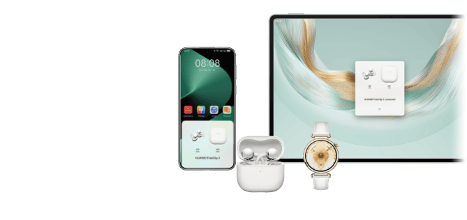 Słuchawki FreeClip2 w białym etui ładującym, obok smartwatch. W tle ekran smartfona oraz ekran tabletu
