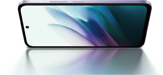 Redmi 15 zwrócony wyświetlaczem do dołu z kolorową tapetą na ekranie