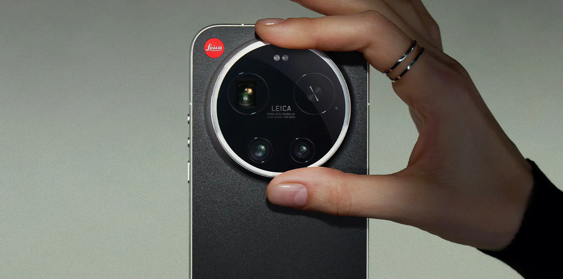 Smartfon Xiaomi z okrągłym modułem aparatu Leica trzymany w dłoni, widok tylnej obudowy