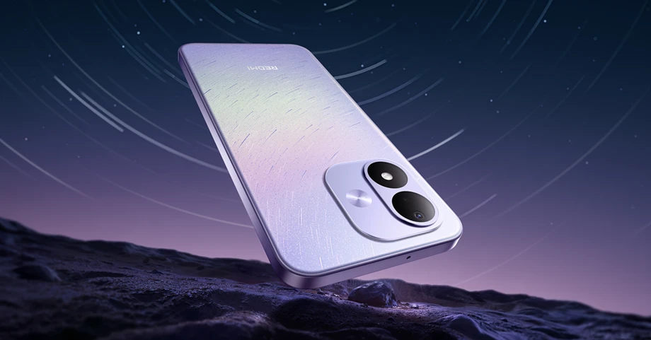 Fioletowy smartfon REDMI pokazany nad skalistym podłożem na tle nocnego nieba