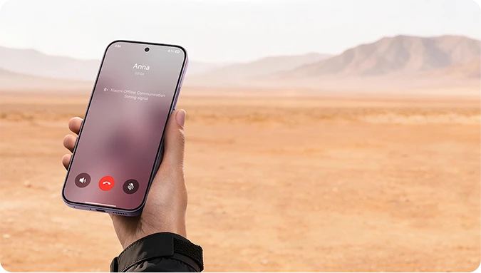 Smartfon Xiaomi z aktywnym połączeniem telefonicznym na tle pustynnego krajobrazu