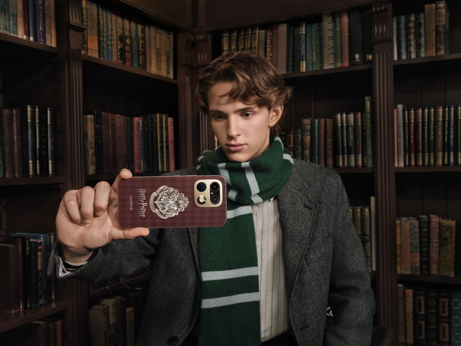 Chłopak fotografujący telefonem realme 16 Pro Harry Potter Edition w bibliotece